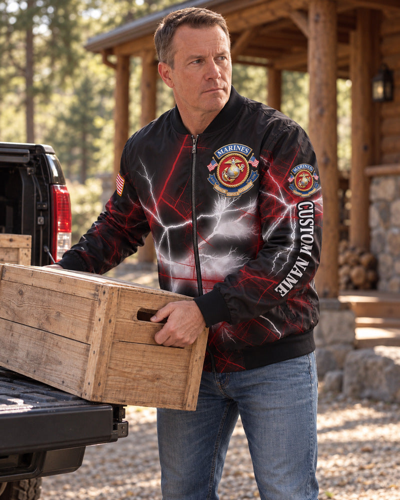A man unloading a crate in a personalized Marine Corps bomber jacket.