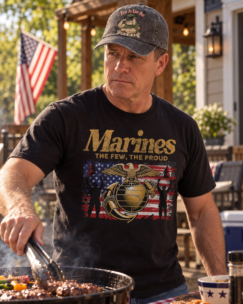 A man grilling outdoors while wearing a Marine Corps baseball cap.