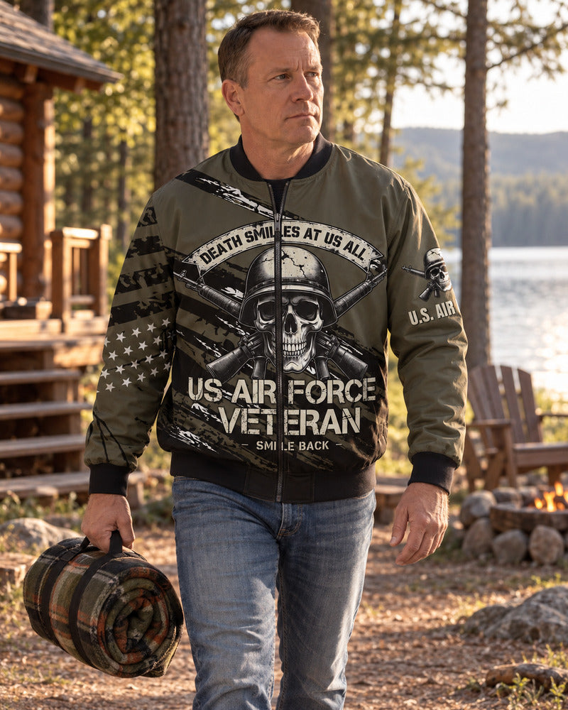 A man carrying a camping blanket in an Air Force bomber jacket.
