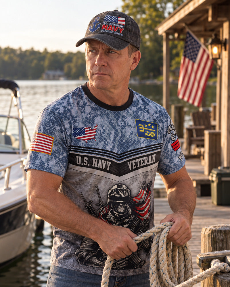 A man working by a lakeside dock while wearing a Navy baseball cap.