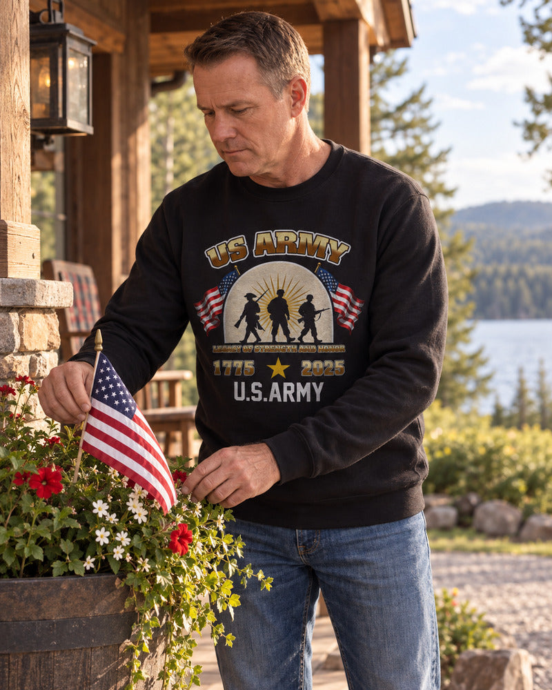 A man arranging a small flag in a planter in an Army sweatshirt.