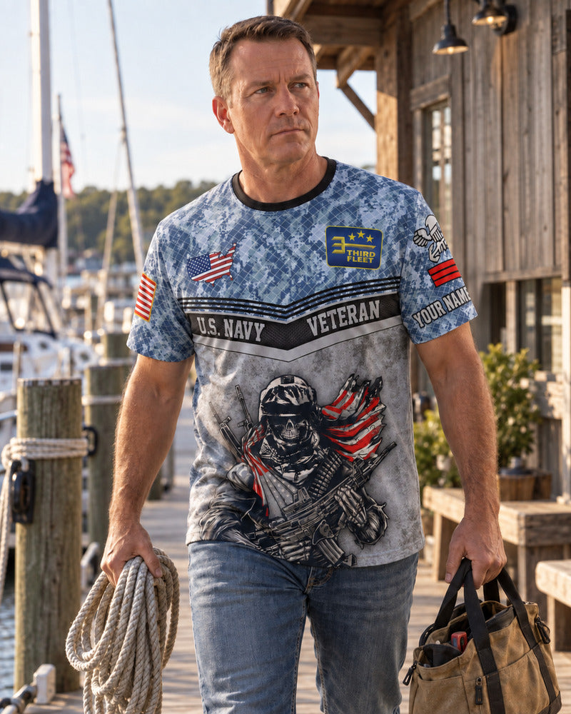A man carrying rope and a tool bag in a personalized Navy AOP T-shirt.